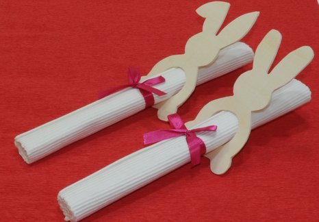 Serviettenhalter aus Holz im Osterhasenmotiv auf einem roten Tuch